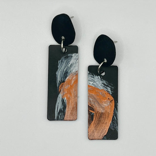 A pair of hand painted recycled rubber earrings