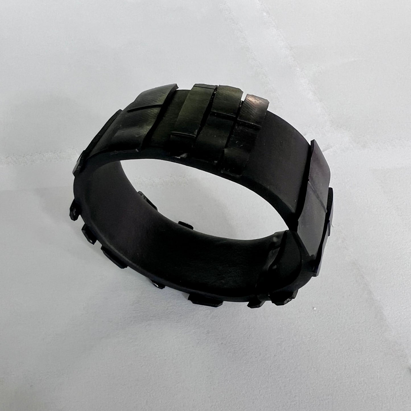 A black Rubber Bangle topped with black rubber shards