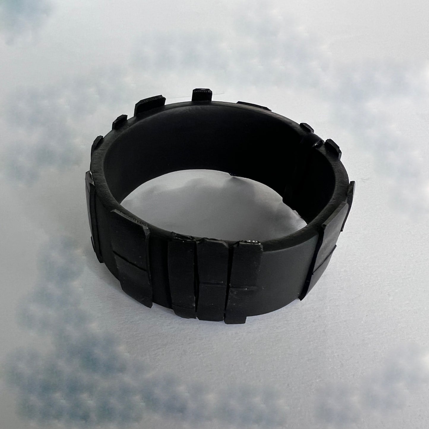 A black Rubber Bangle topped with black rubber shards