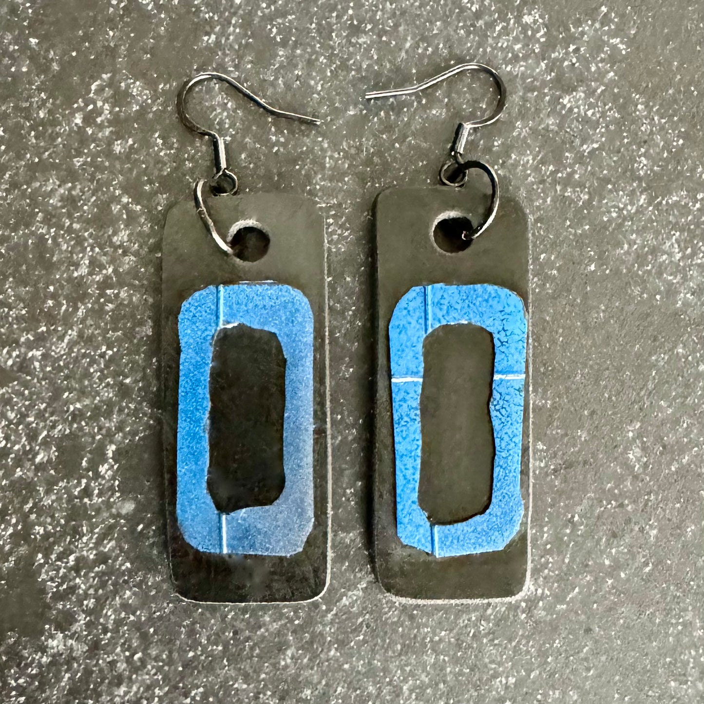 A pair of black and blue drop earrings