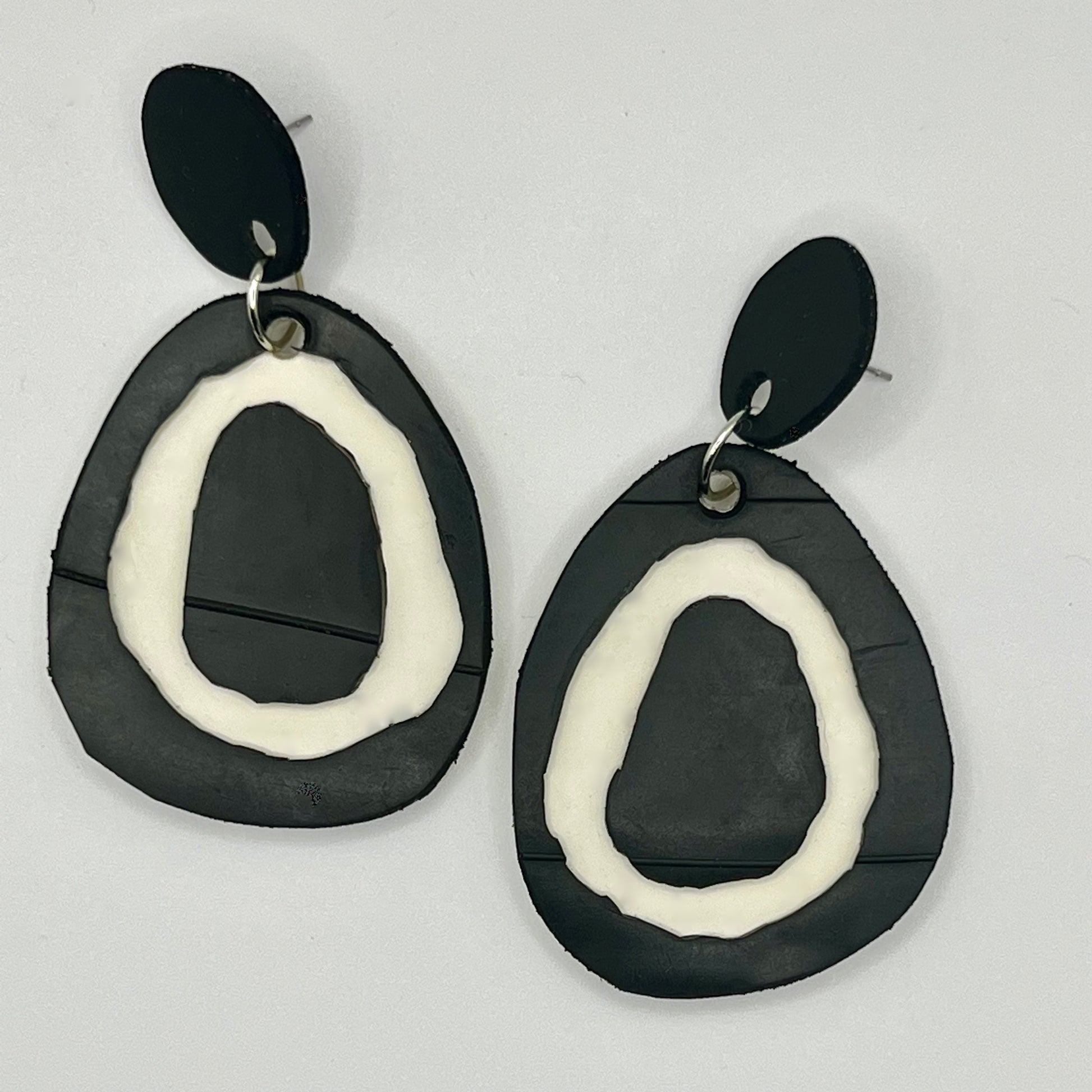 A pair of black and white rubber earrings