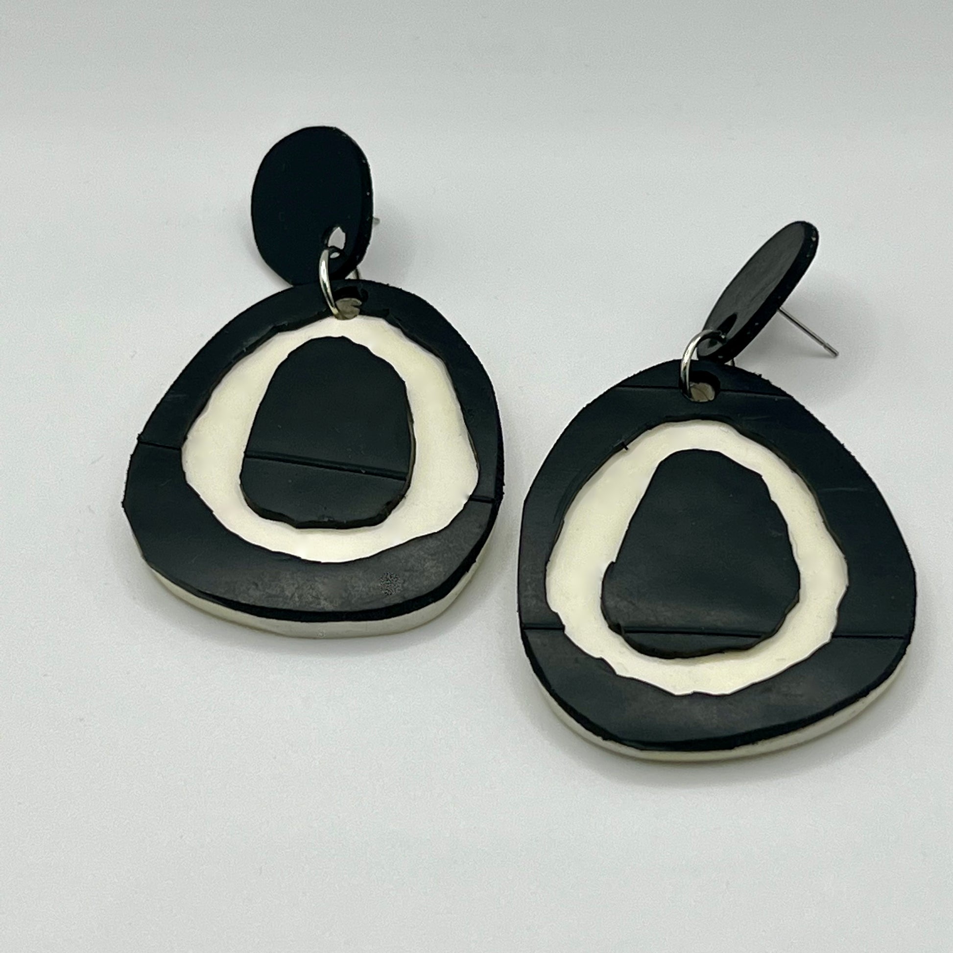 A pair of black and white stud dangle earrings