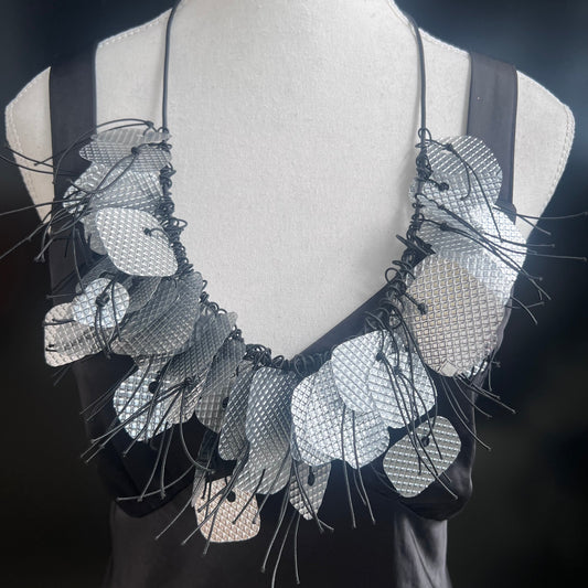 A mannequin wears a recycled silver necklace
