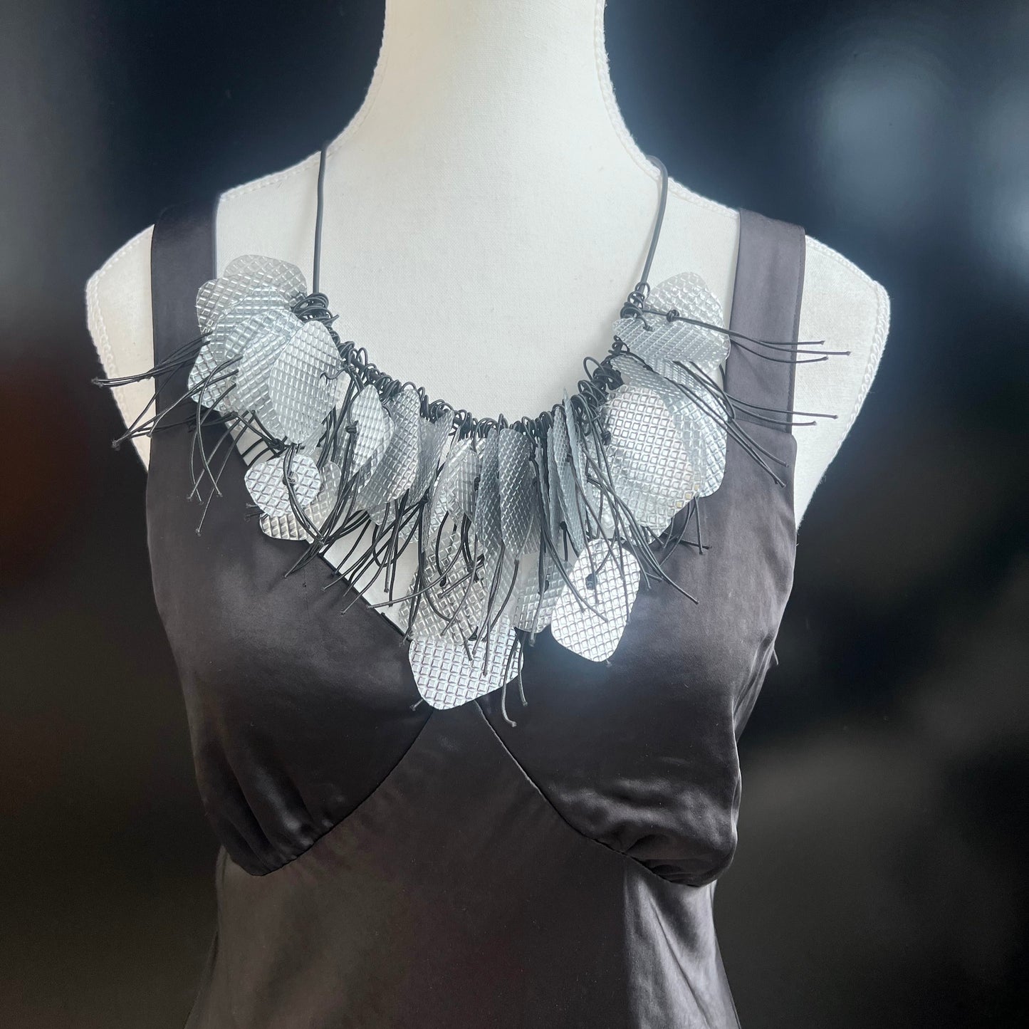 A mannequin wears a recycled silver necklace