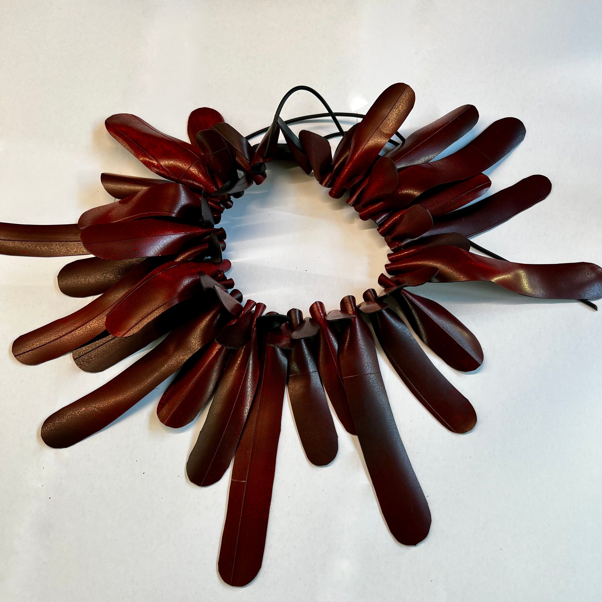 A frilly red rubber necklace