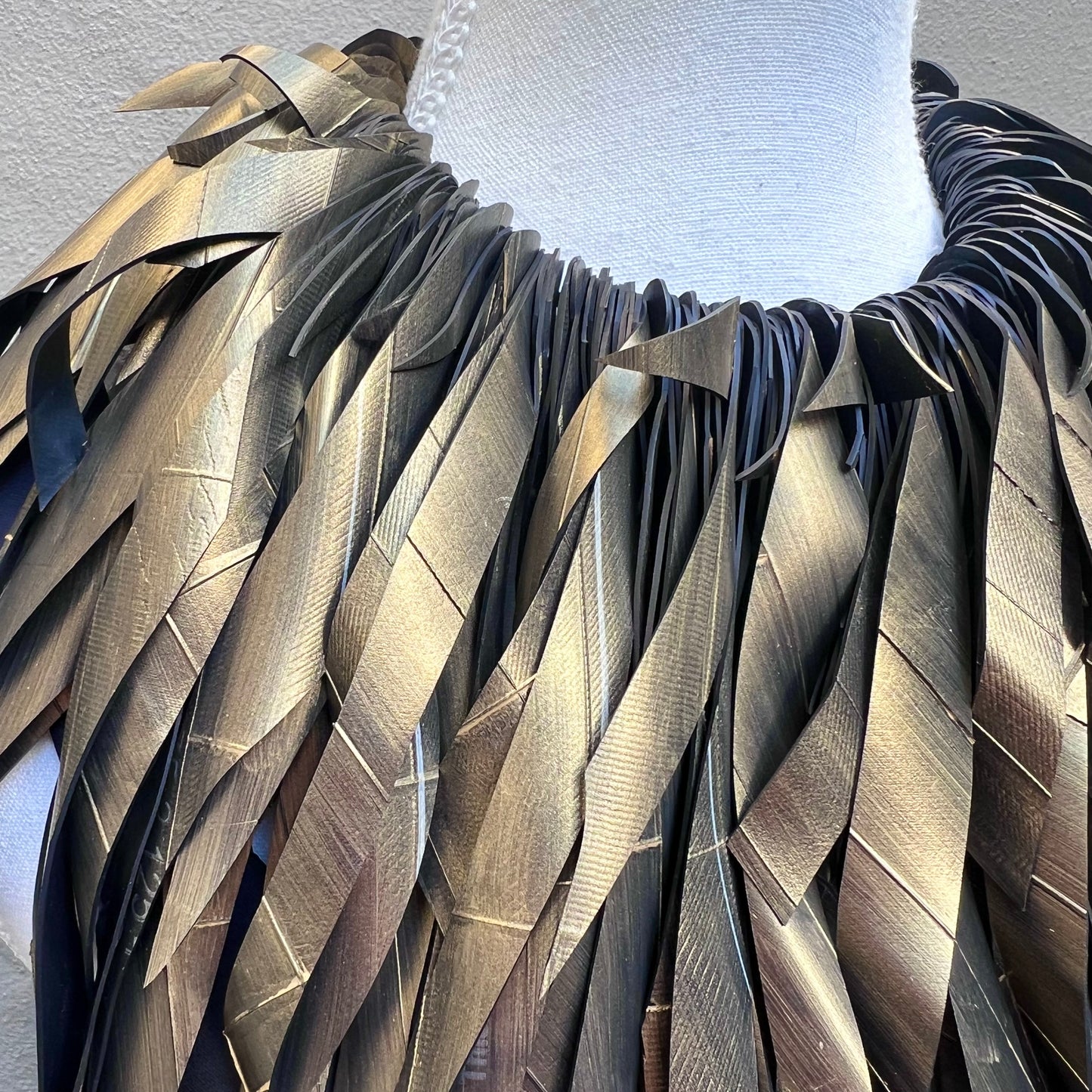 Close-up of a gold painted necklace.