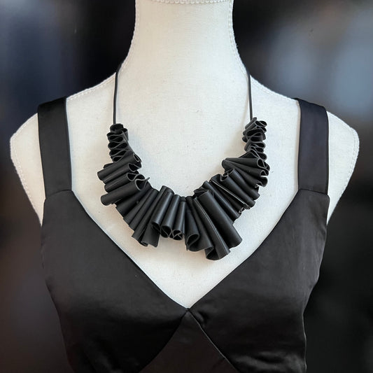 A mannequin wears a contemporary rubber necklace
