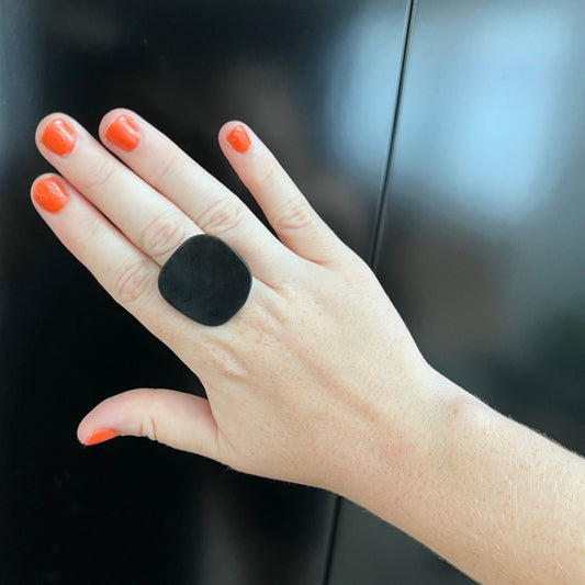 An organic shaped rubber ring on a hand