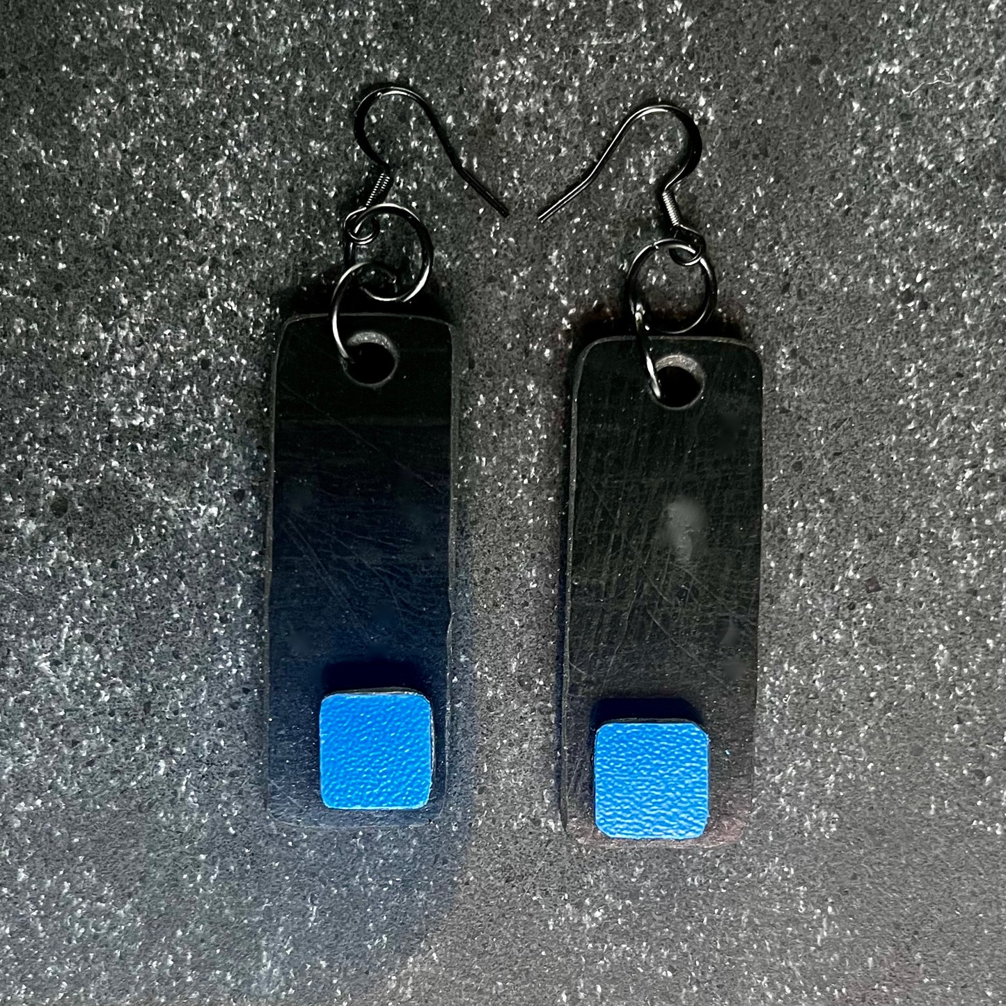 A pair of black and blue  salvaged rubber and plastic earrings