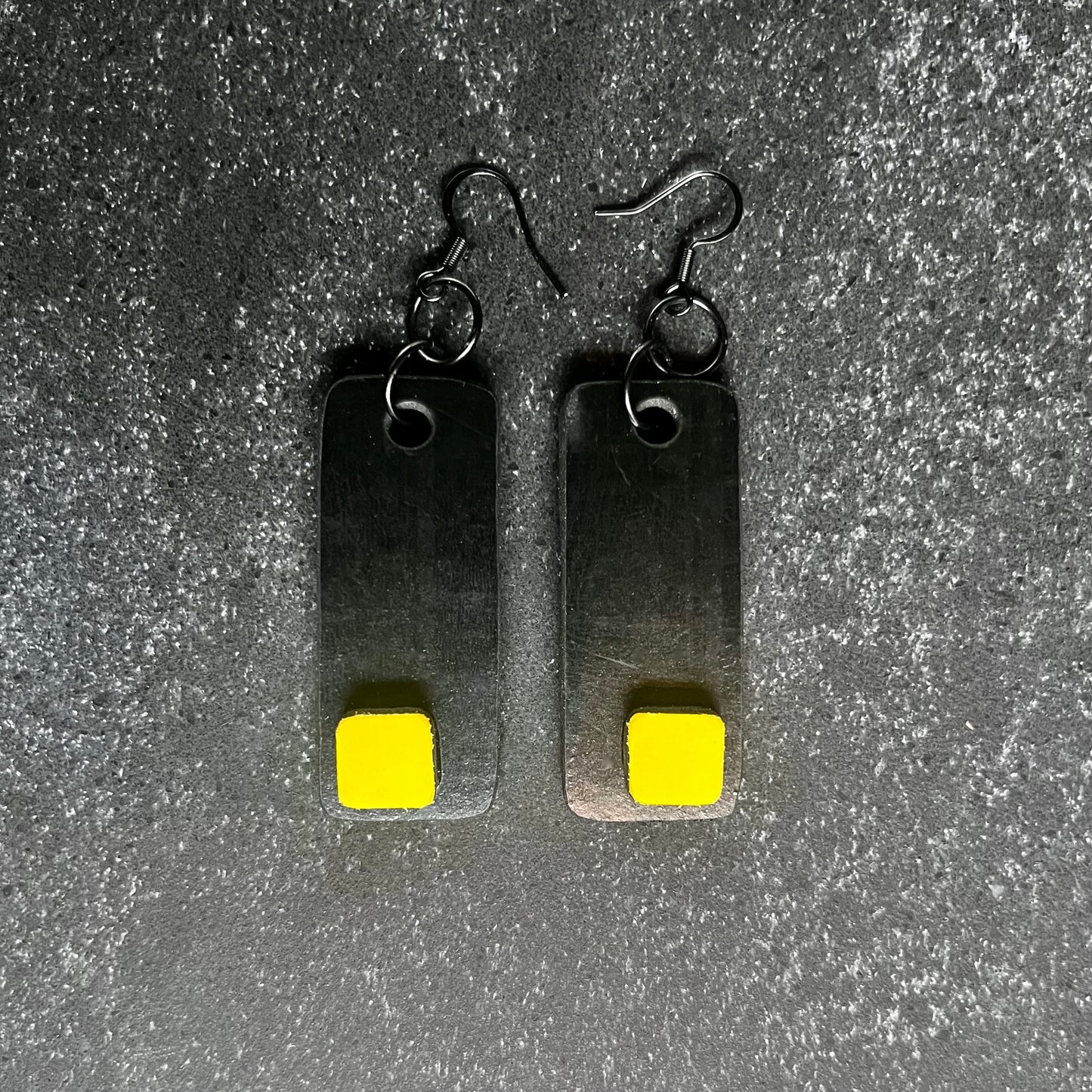 A pair of salvaged rubber and plastic black and yellow earrings