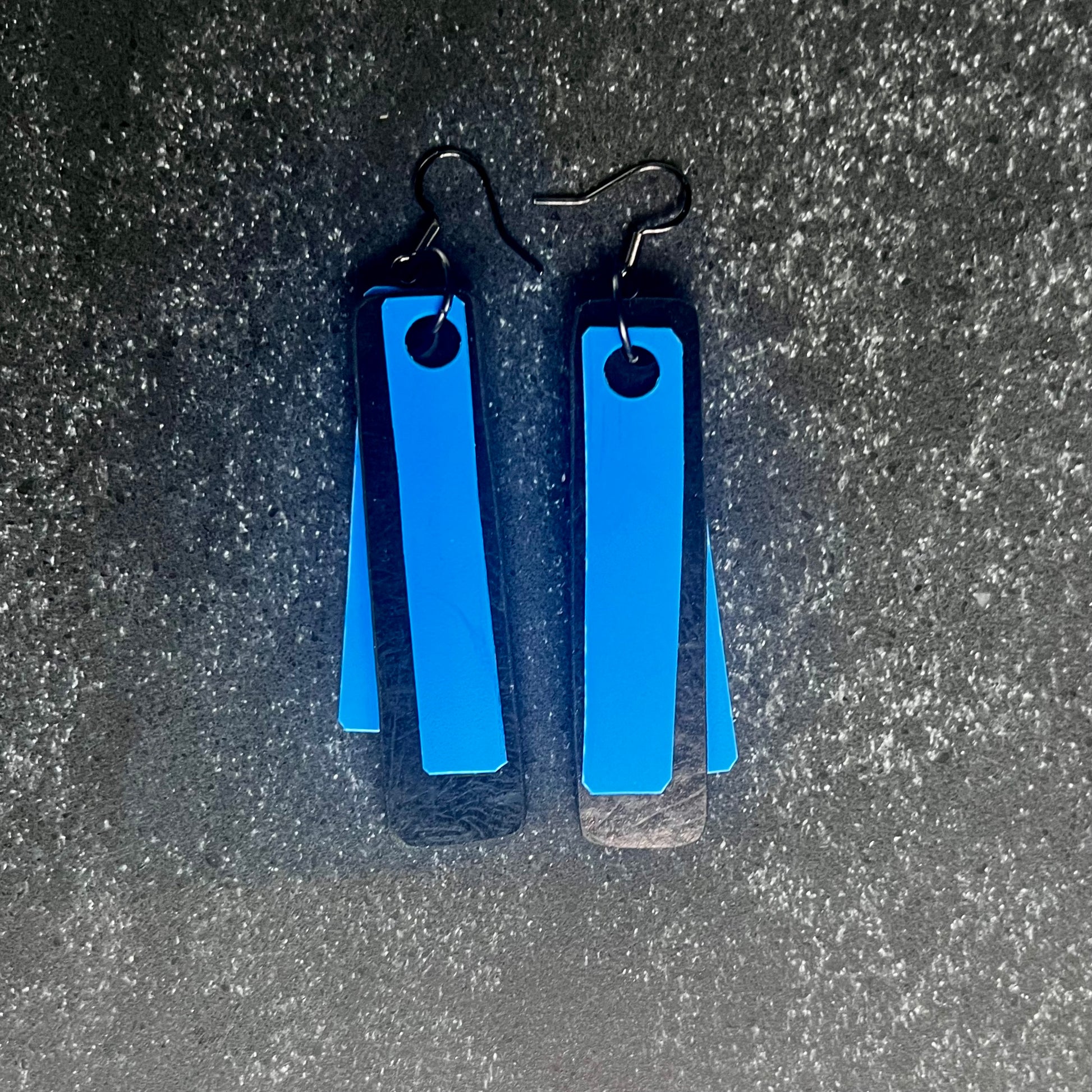 A pair of blue and black earrings