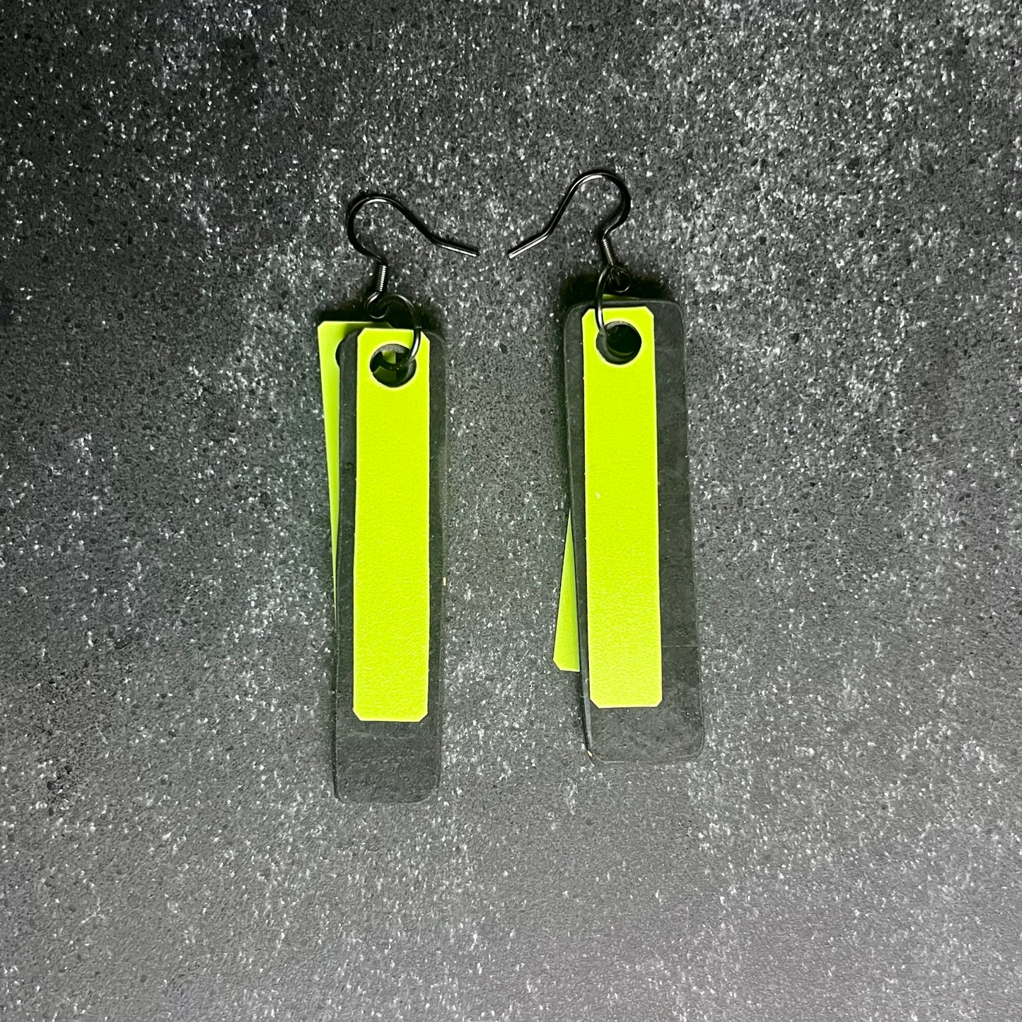 A pair of green and black earrings