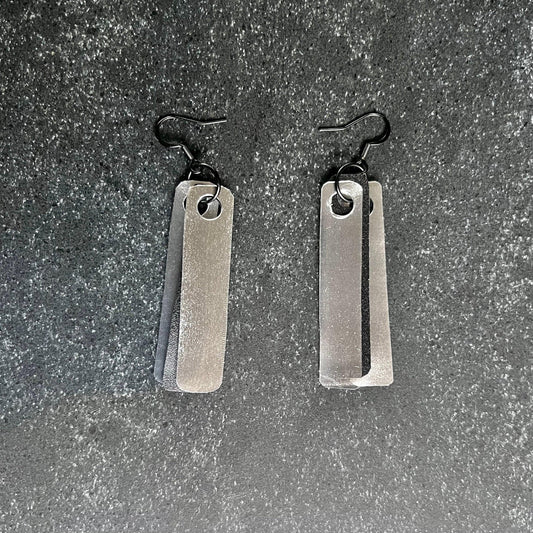 Earrings of two-tone plastic strips