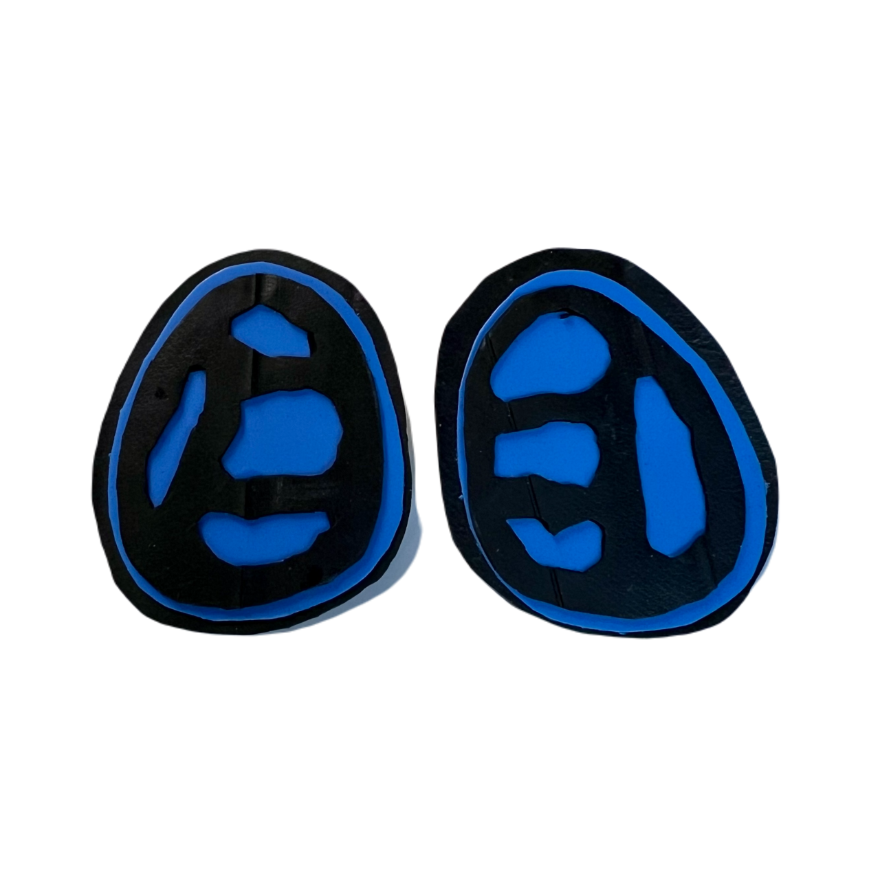 A pair of blue and black stud earrings with a fossil like cut out effect