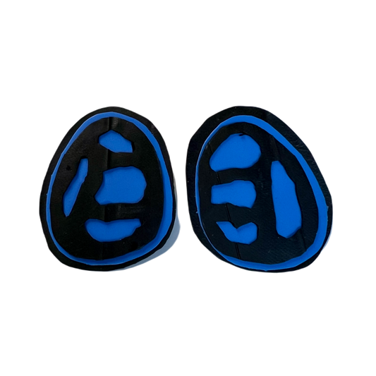 A pair of blue and black stud earrings with a fossil like cut out effect