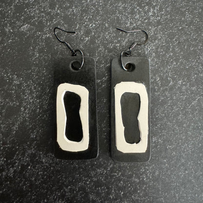 A pair of black and white rubber earrings