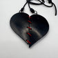 A rubber heart necklace with two pieces joined together