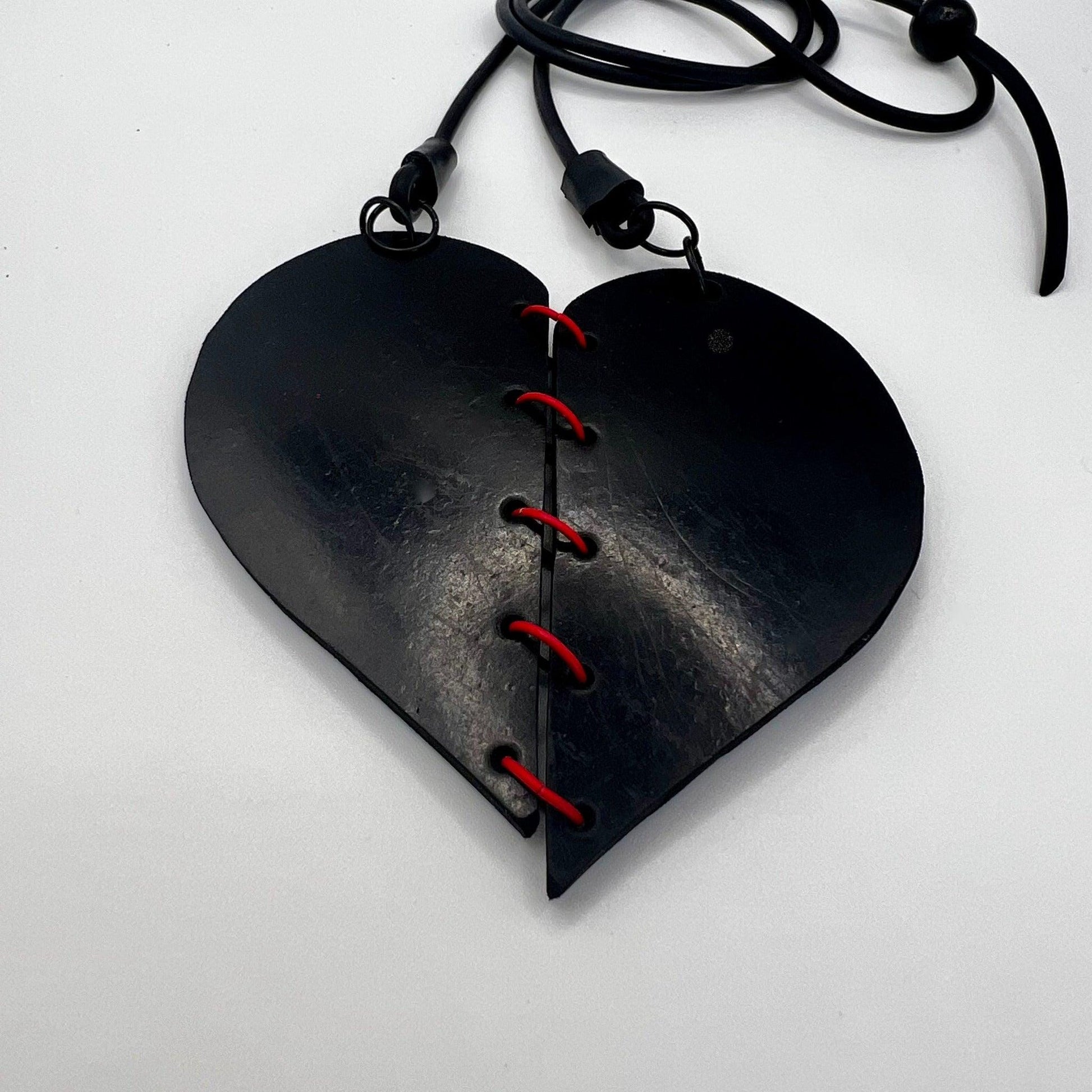 A rubber heart necklace with two pieces joined together
