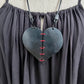 A rubber heart necklace with two pieces joined together