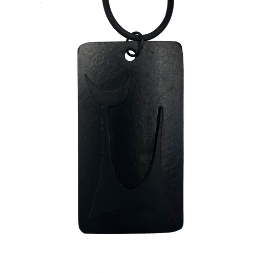 An oblong rubber pendant featuring a mid century style cat