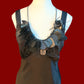 A mannequin wears a black plastic necklace made from x-rays