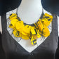 A mannequin wears a yellow and black necklace