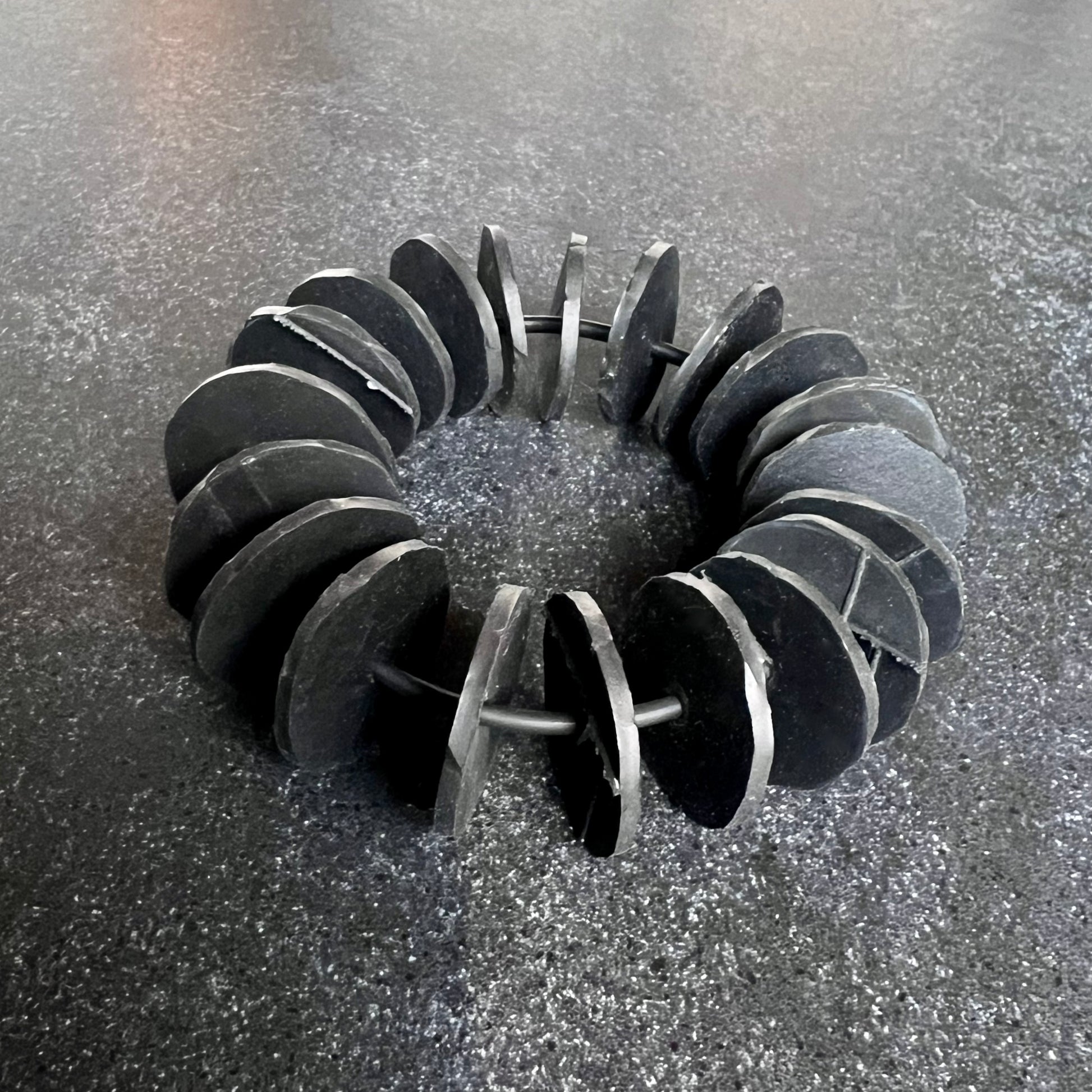 A bracelet made from many rubber inner tube discs