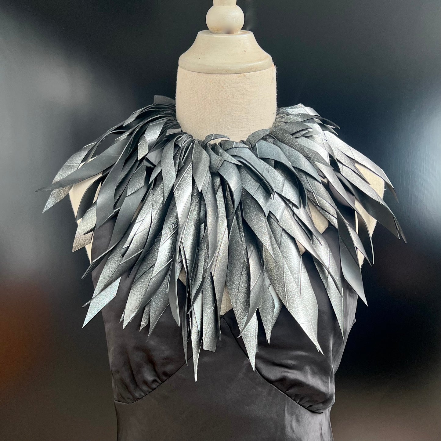 A mannequin wears a hand painted large grey silver rubber necklace