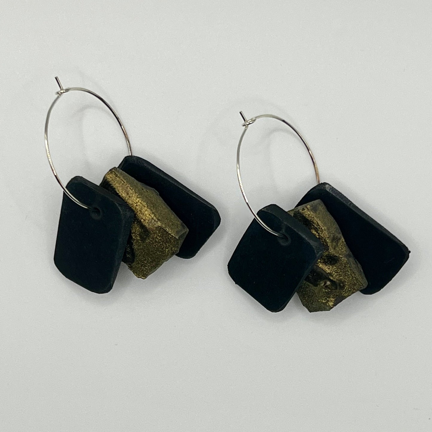 A pair of rubber and painted rubber earrings on silver hoops