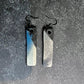 A pair of rubber earrings with spray painted blue and silver colour