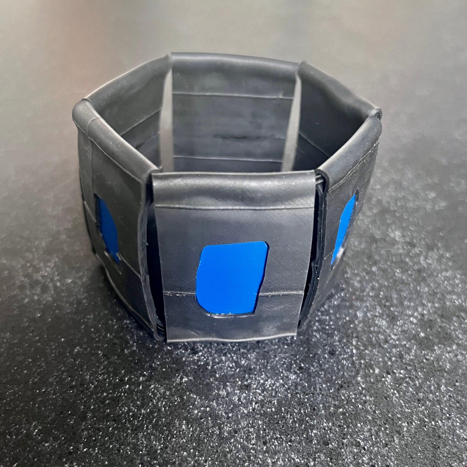 A large rubber and blue plastic bracelet