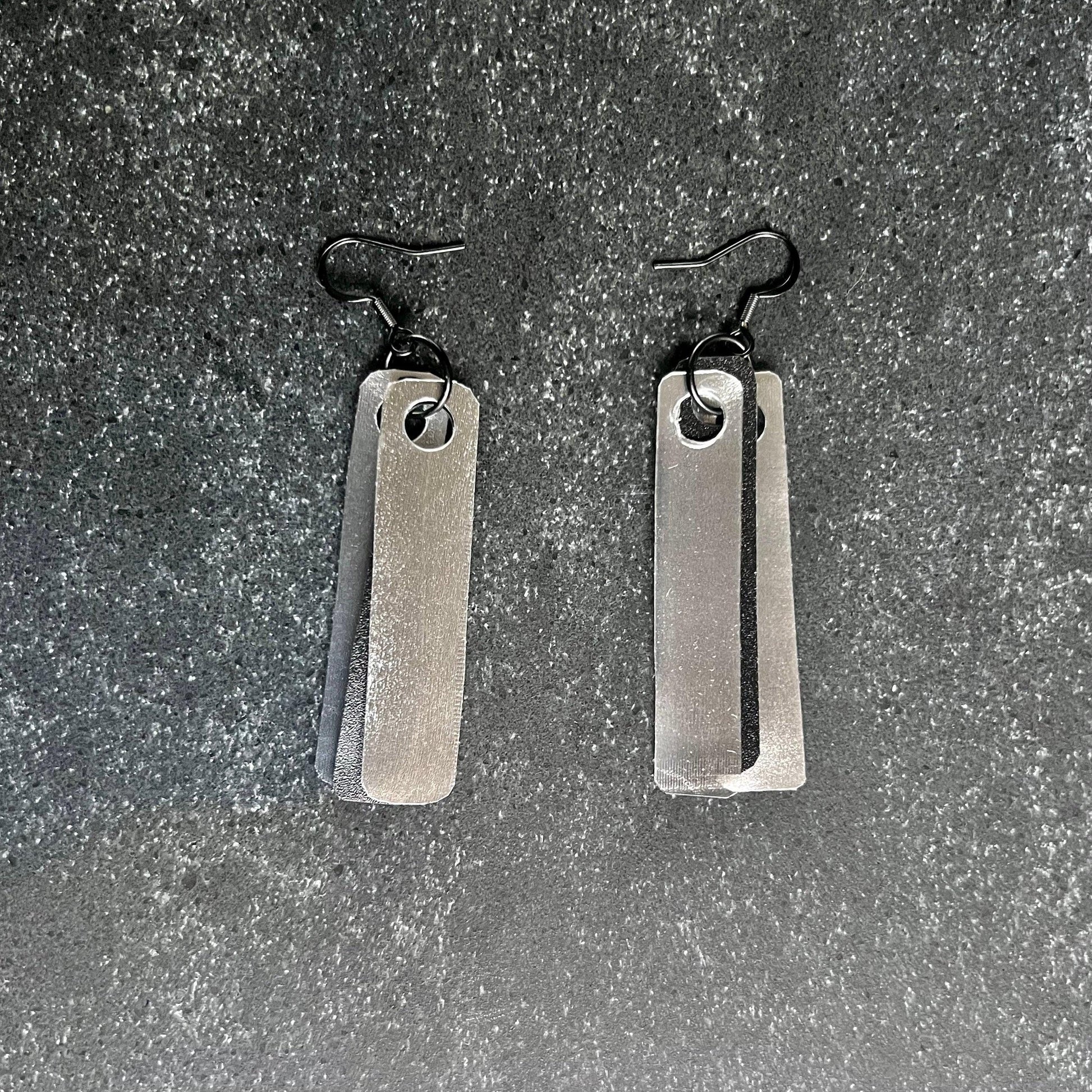 Silver and black plastic earrings that are very lightweight