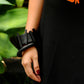 A woman wearing a black rubber bangle