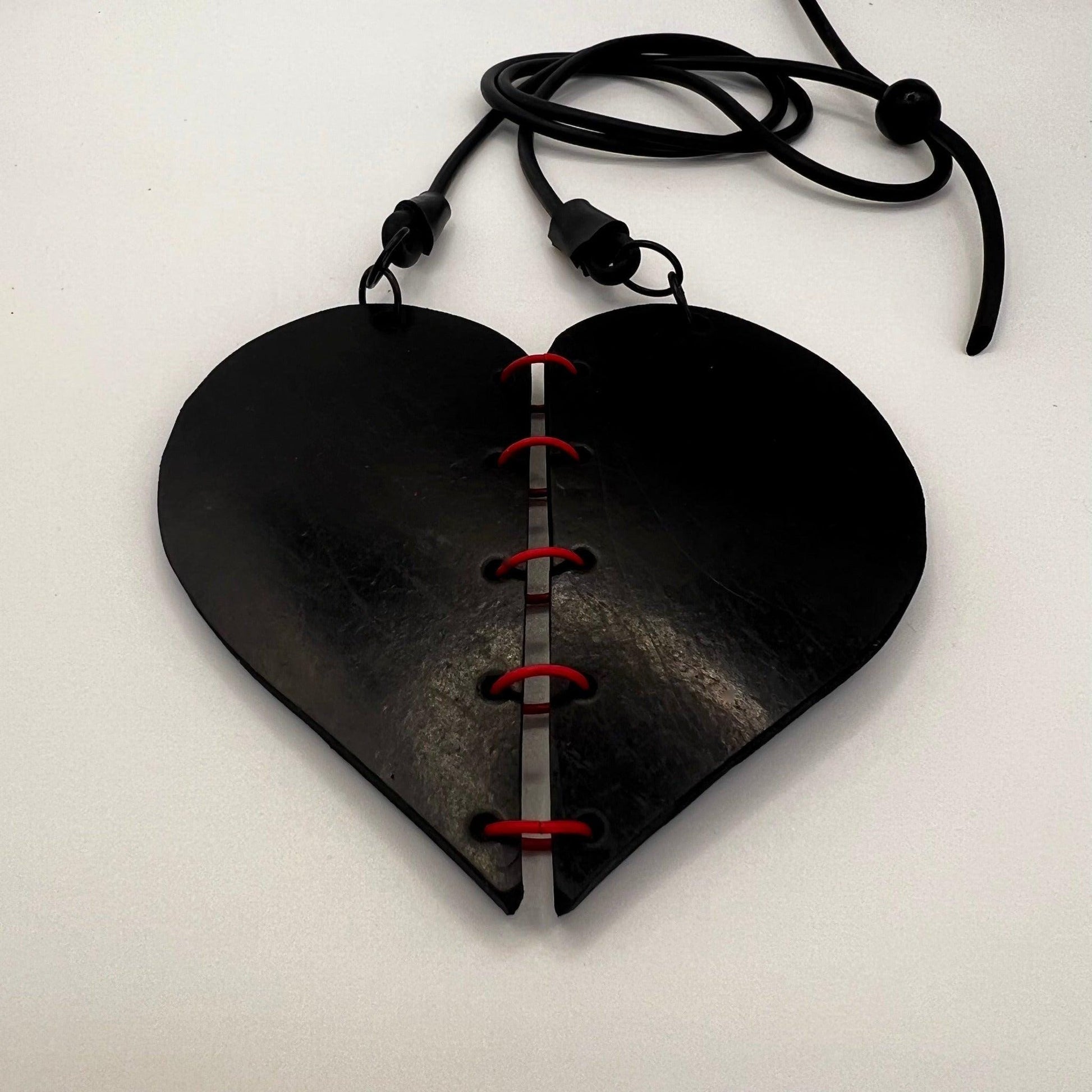 A rubber heart necklace with two pieces joined together