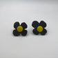 A pair of black and yellow daisy shaped earrings