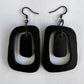 A pair of black rubber earrings