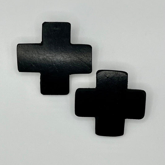 A pair of black earrings made of rubber and shaped like a cross