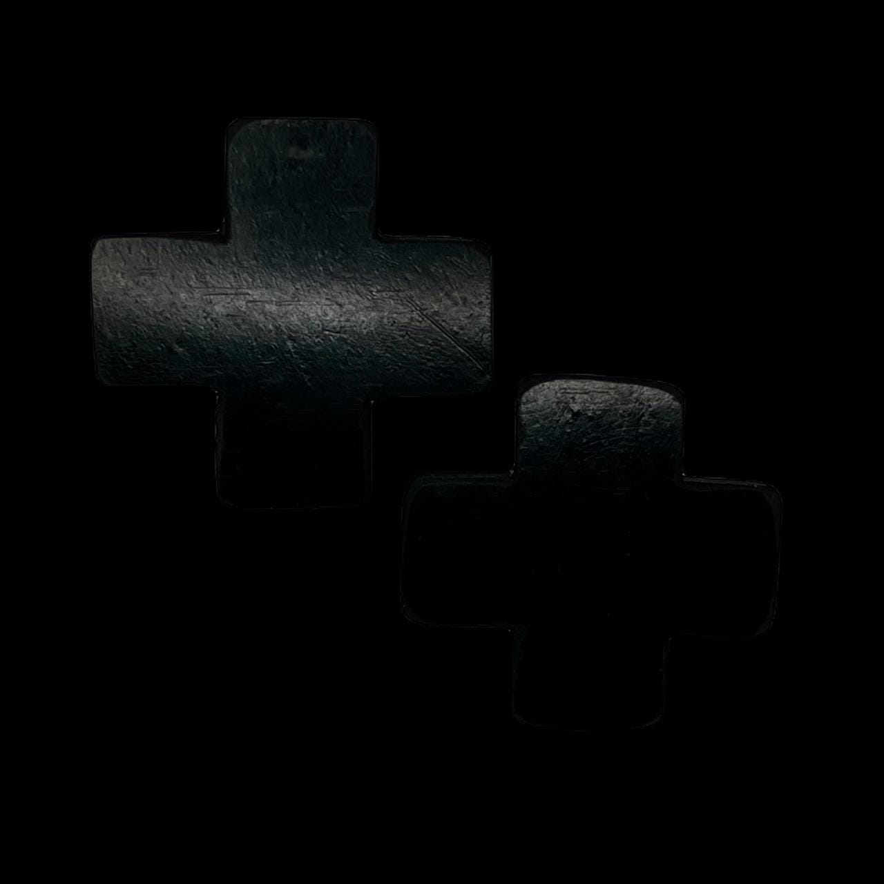 A pair of black earrings made of rubber and shaped like a cross