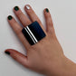 A woman&#39;s hand wearing a large black and white repurposed rubber ring