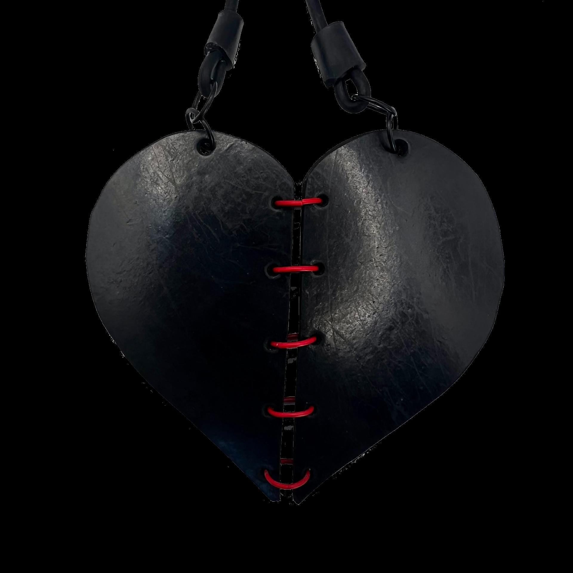 A heart necklace in two pieces held together with red rings