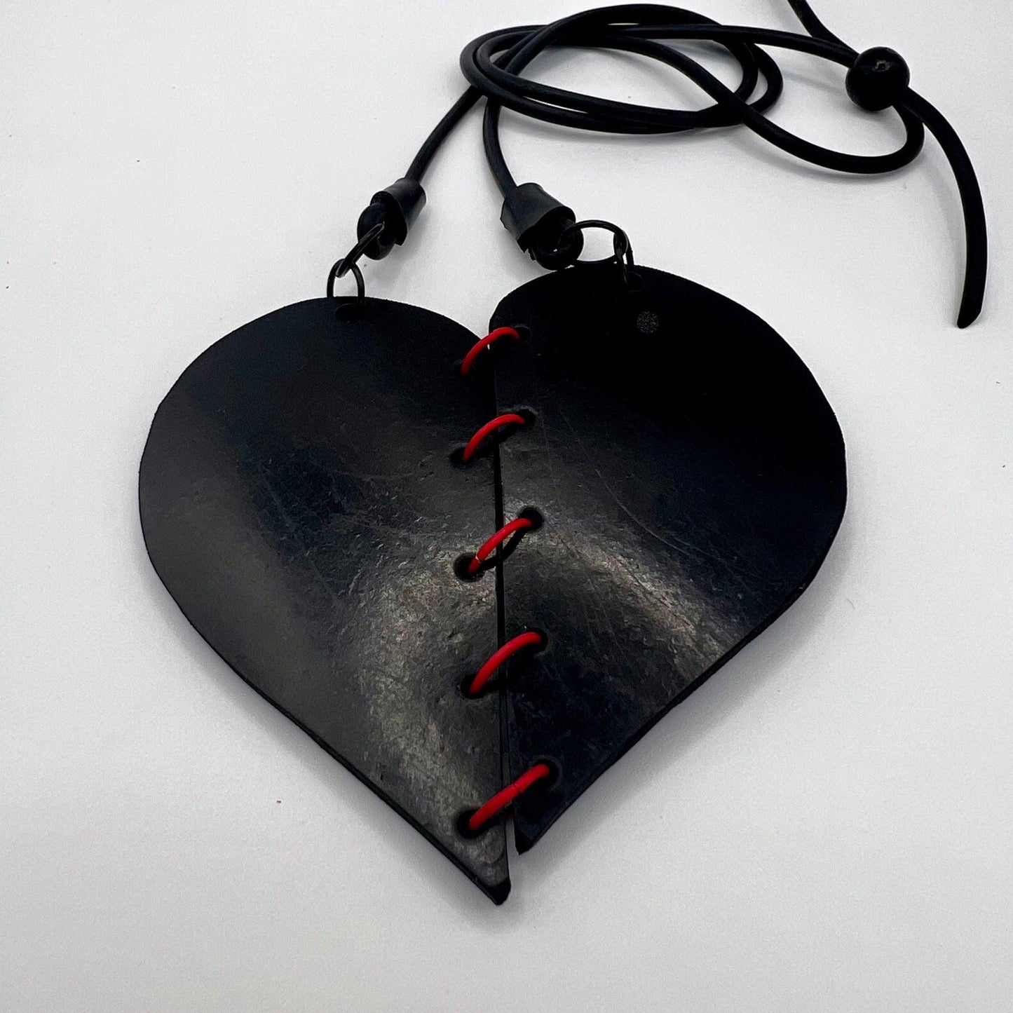 A rubber heart necklace with two pieces joined together