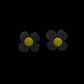 Daisy shaped stud earrings made from black rubber and a yellow metal centre