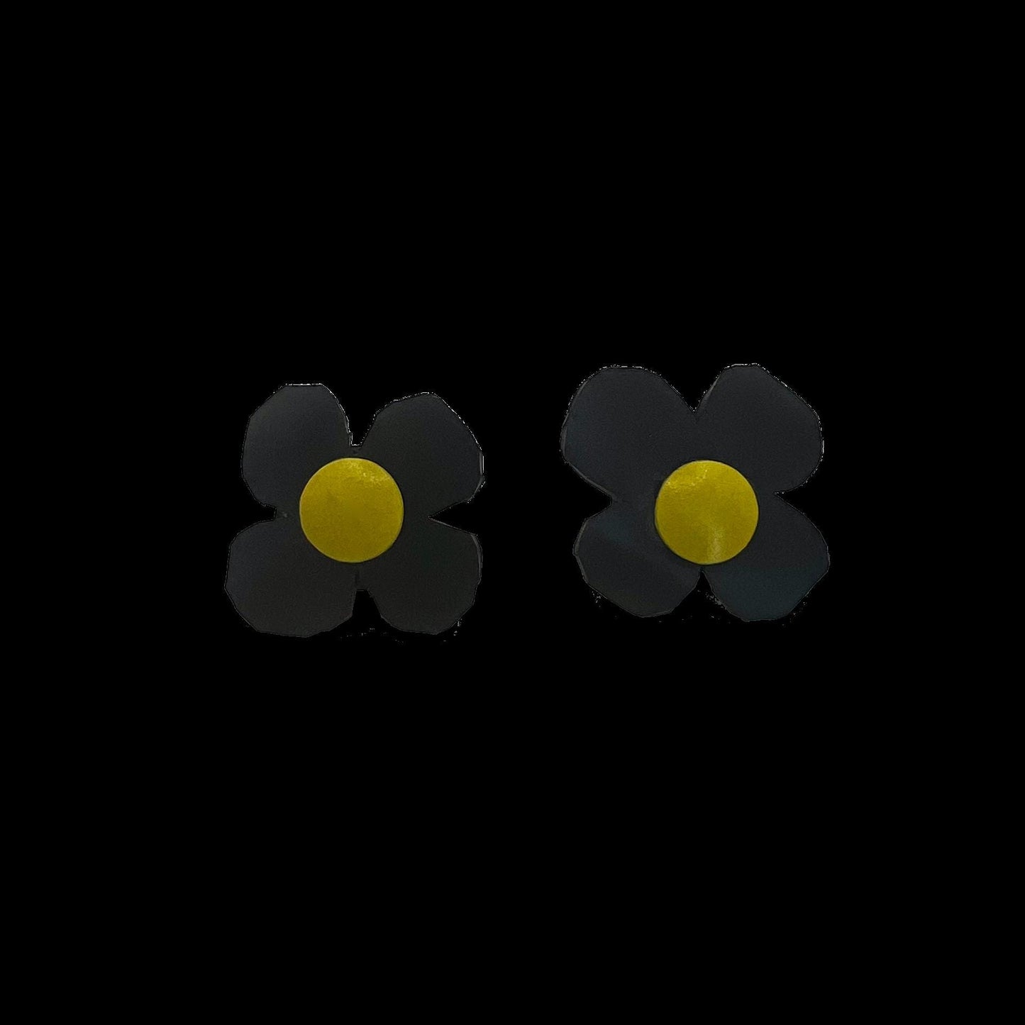 Daisy shaped stud earrings made from black rubber and a yellow metal centre