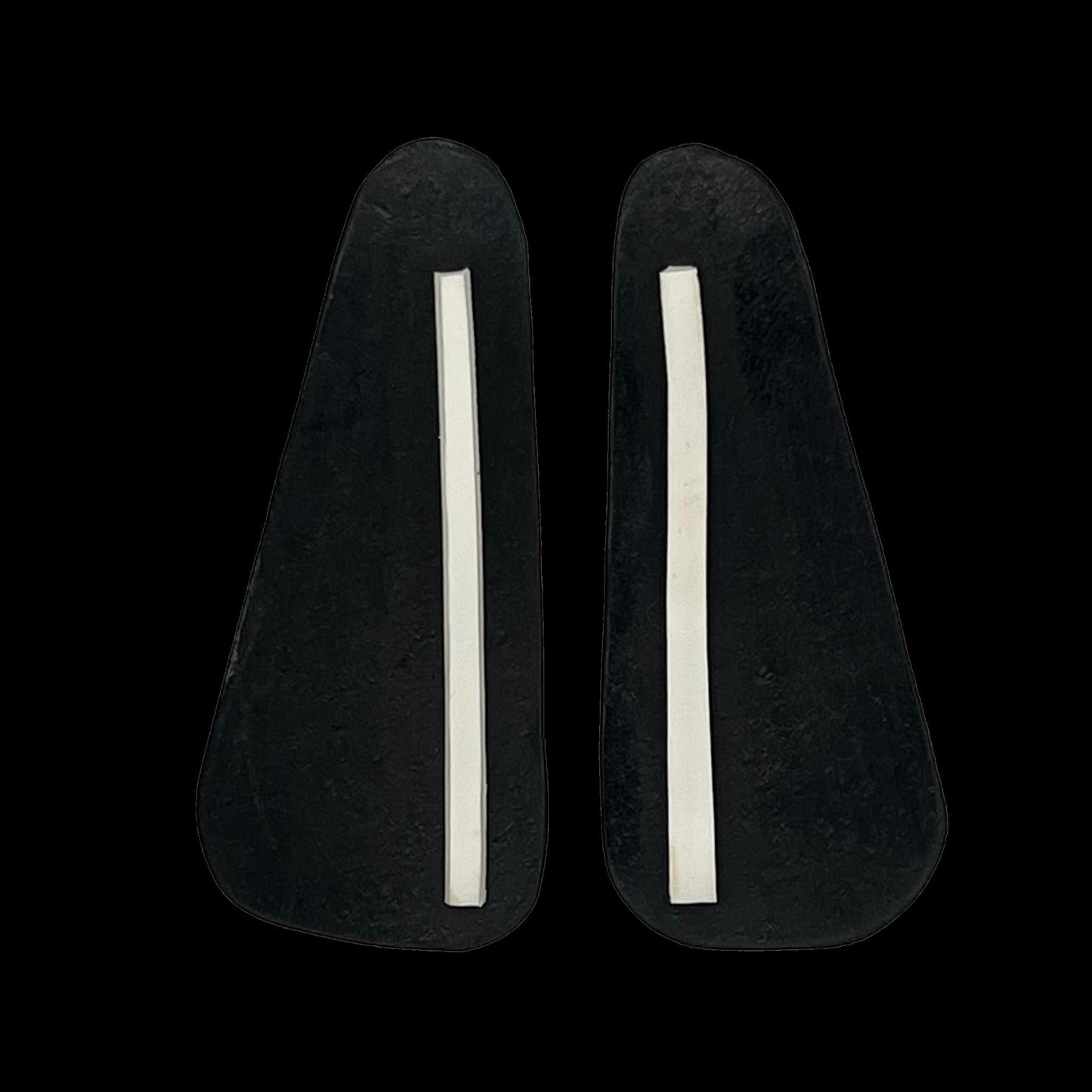 A pair of black and white rubber earrings