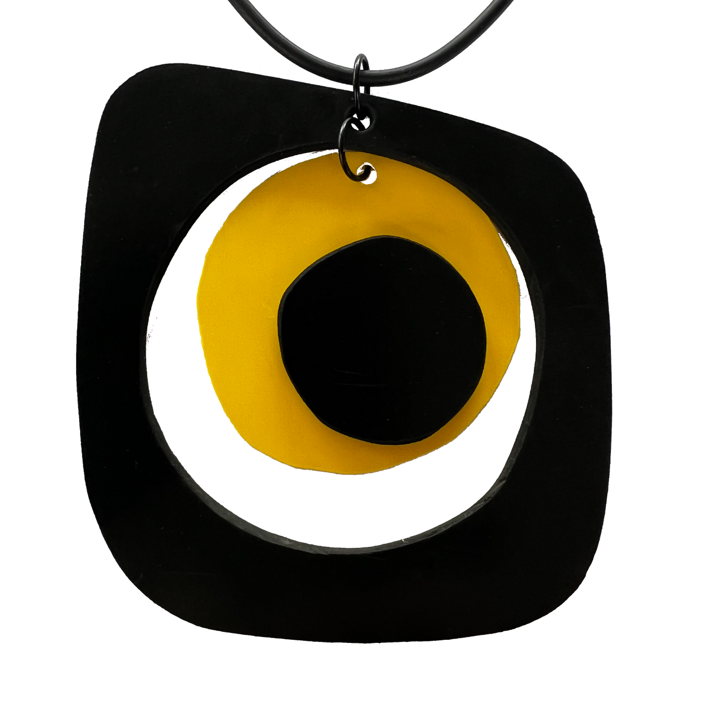 A rubber pendant with a yellow disc