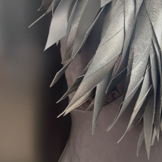 A  video showing a mannequin wears a hand painted large grey silver rubber necklace