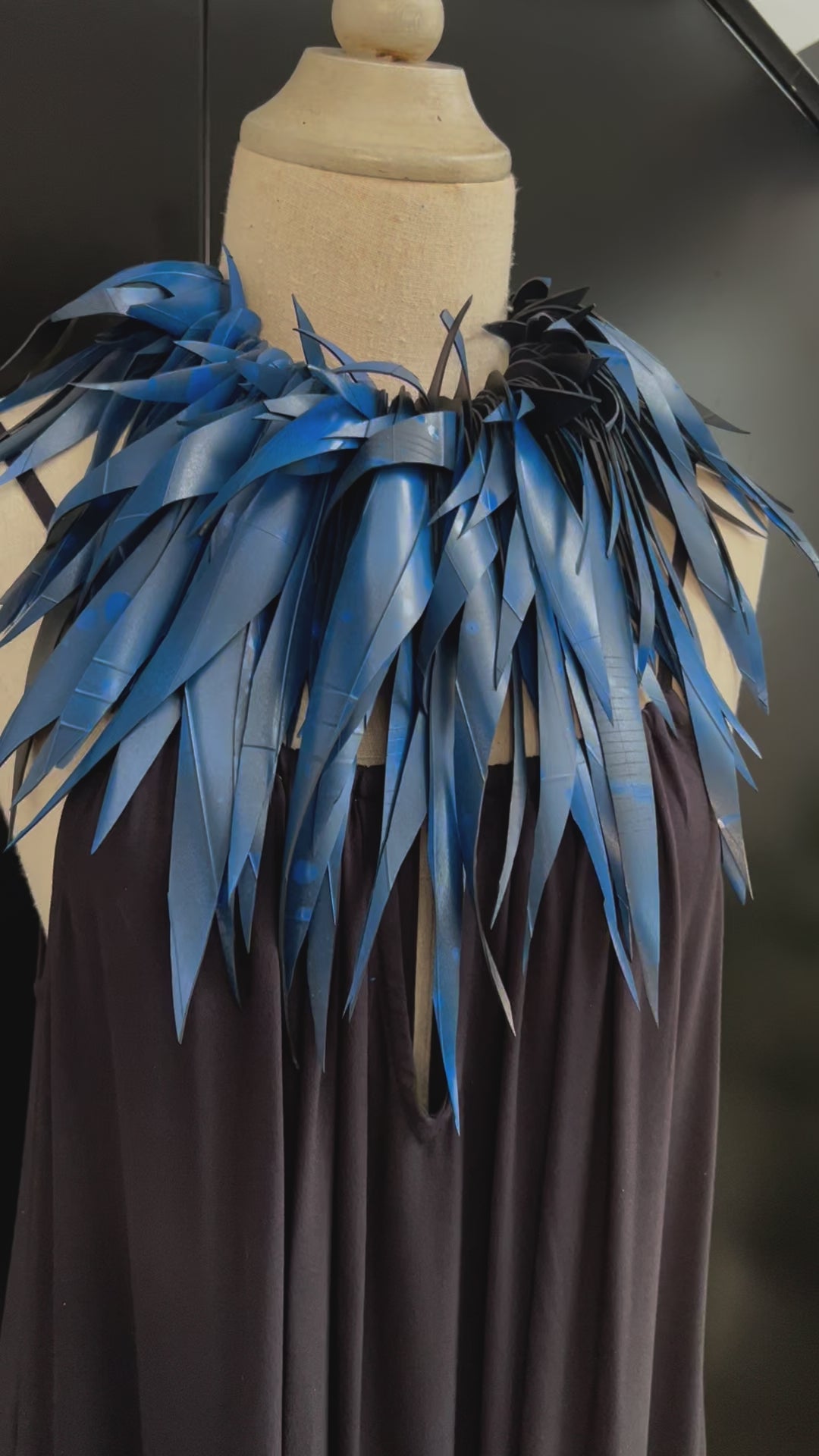 A video showing movement of a large blue rubber necklace