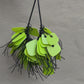 A necklace made from green coloured recycled plastic spins in the sunlight
