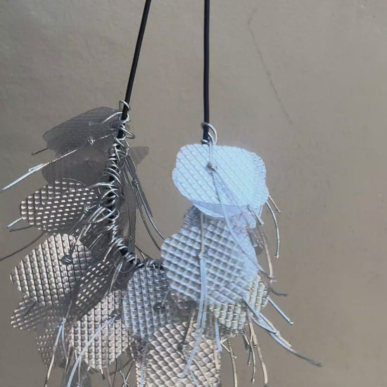 A silver necklace spins around