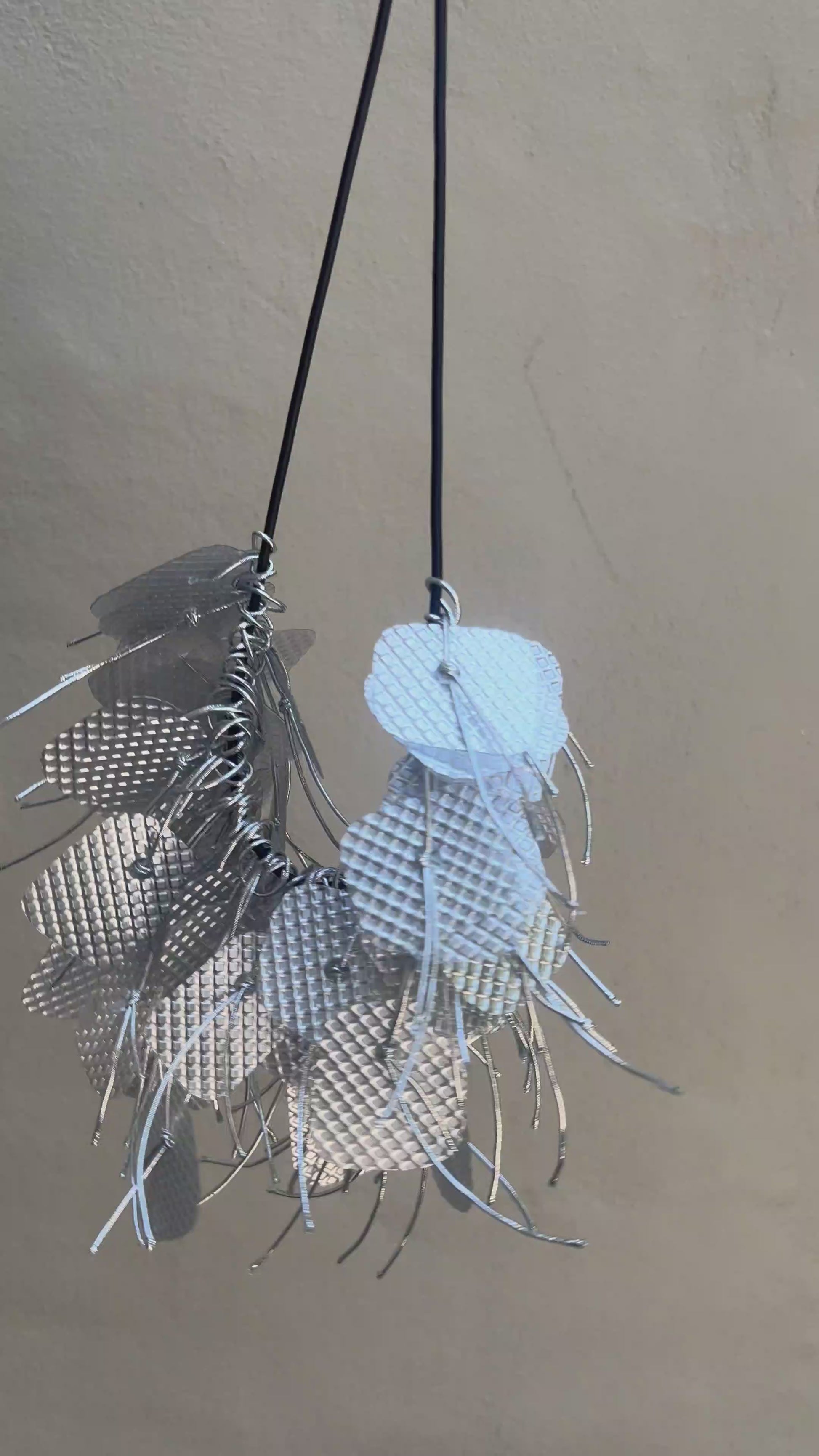 A silver necklace spins around